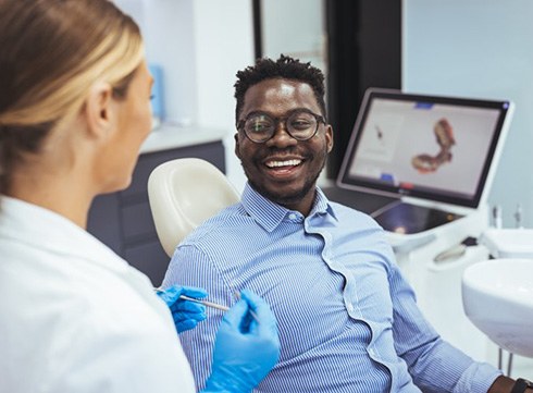 Patient in Corpus Christi talking to periodontist about dental implants