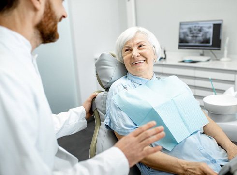 an older patient talking with her dentist