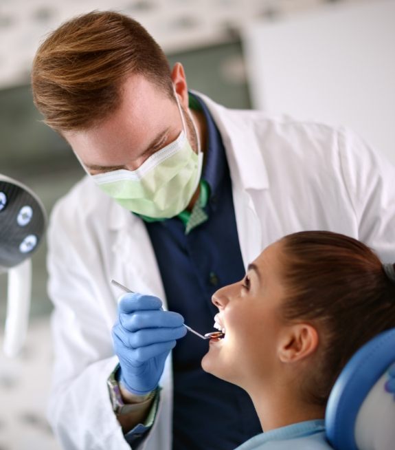 Dentist treating dental patient using state of the art dental technology