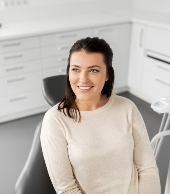 Woman smiling during dental implant consultation