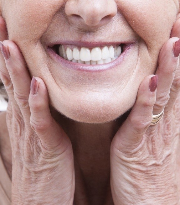 Closeup of full smile after tooth replaced with dental implants