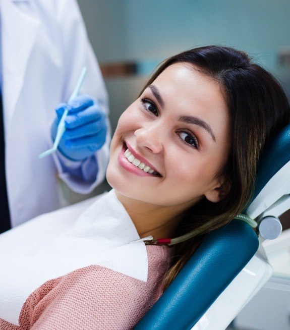 Woman smiling during visit with her periodontist