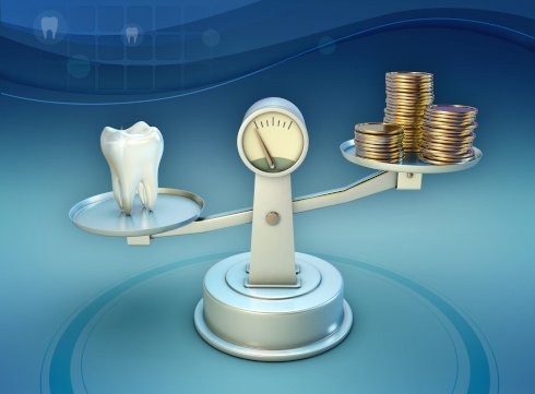 Tooth and coins on a balance scale