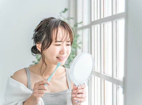 a patient examining their smile in a mirror