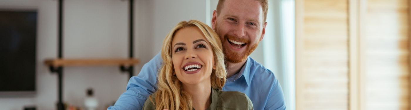 Man and woman smiling after periodontal therapy