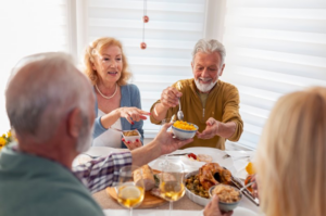 Man at Thanksgiving table excited to enjoy more food with dental implants